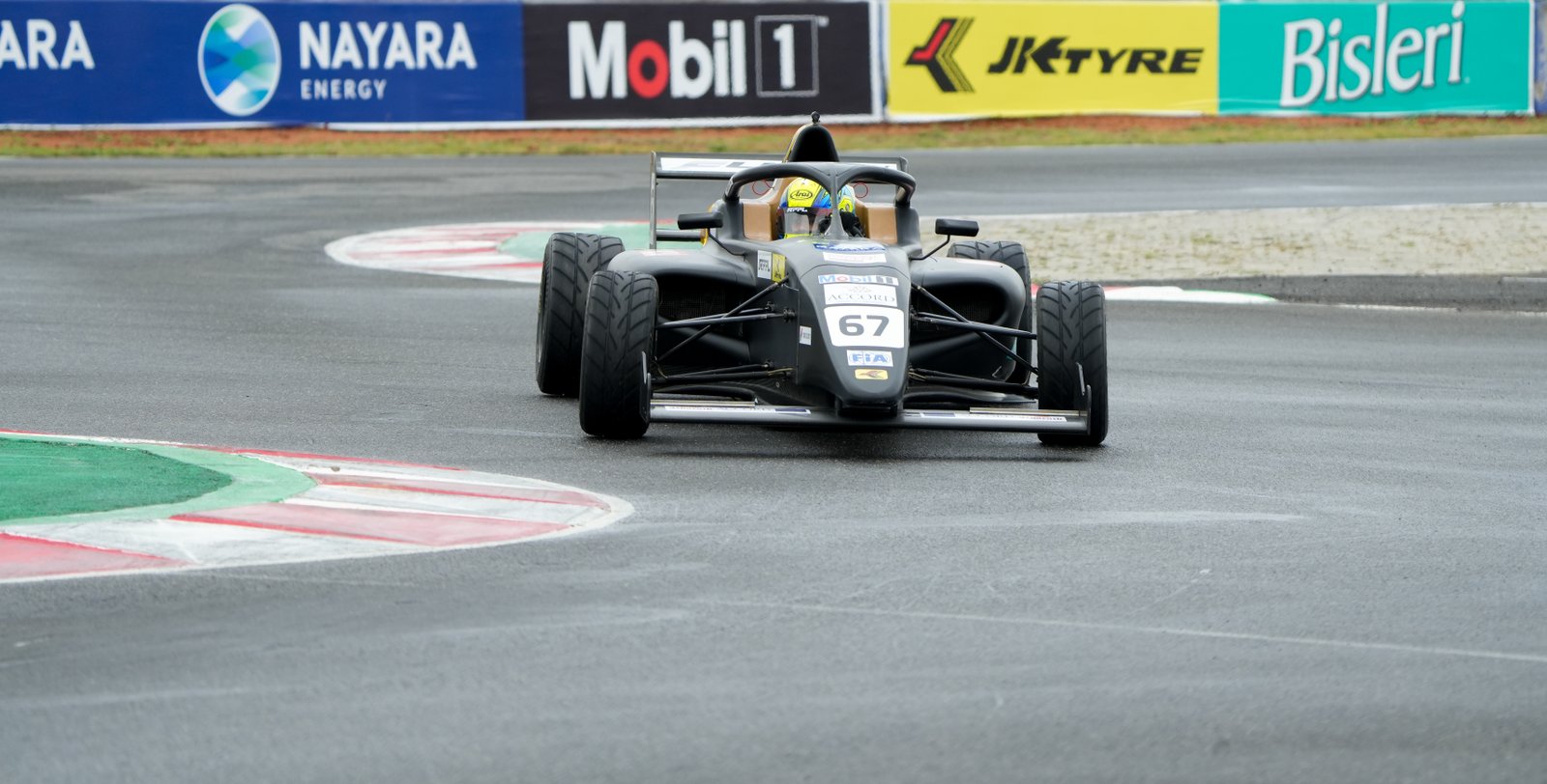 Formula 4 car through the final corner