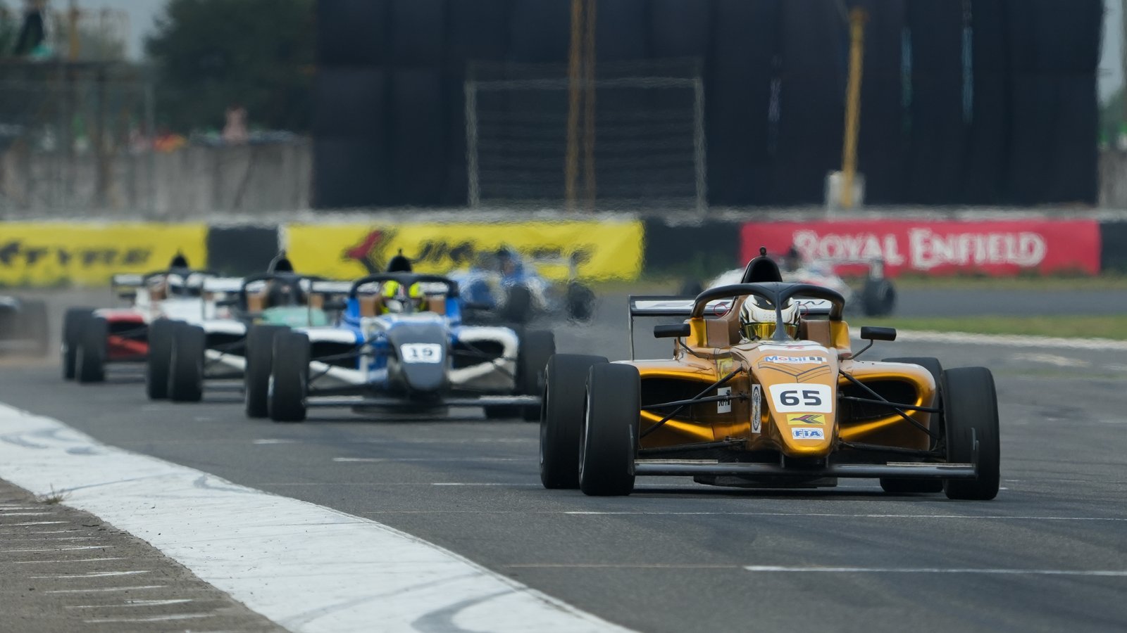 Formula 4 cars through the chicane